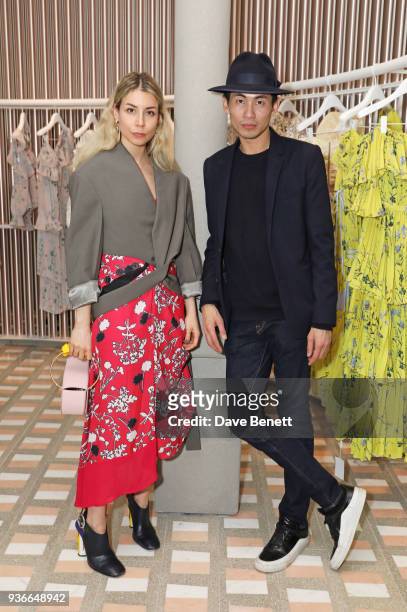 Irina Lakicevic and Han Chong, Self-Portrait Founder and Creative Director, attend the Self-Portrait store opening cocktail party on March 22, 2018...