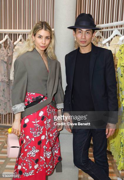 Irina Lakicevic and Han Chong, Self-Portrait Founder and Creative Director, attend the Self-Portrait store opening cocktail party on March 22, 2018...