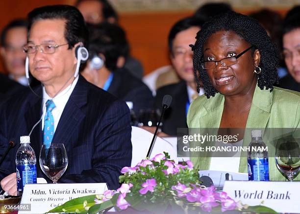 Vietnamese Prime Minister Nguyen Tan Dung listens as World Bank's country director Victoria Kwakwa addresses the opening session of the annual...