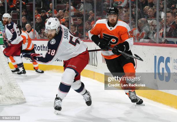 Michael Raffl of the Philadelphia Flyers battels against David Savard of the Columbus Blue Jackets on March 15, 2018 at the Wells Fargo Center in...