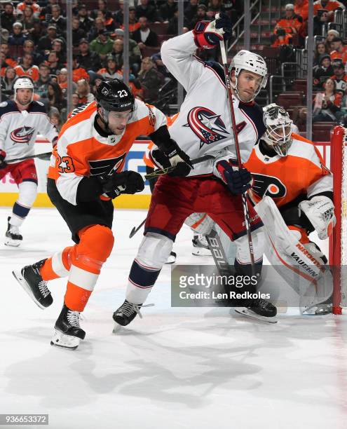 Boone Jenner of the Columbus Blue Jackets battles in the crease against Brandon Manning and Alex Lyon of the Philadelphia Flyers on March 15, 2018 at...