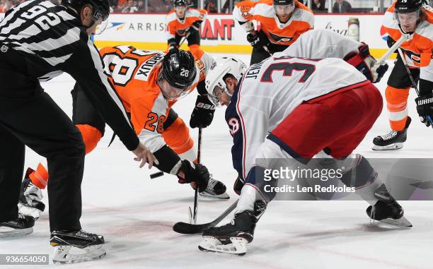 Lineman Mark Shewchyk drops the puck on a face-off between Claude Giroux of the Philadelphia Flyers and Boone Jenner of the Columbus Blue Jackets on...