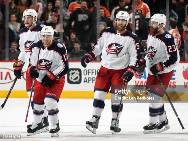 Cam Atkinson of the Columbus Blue Jackets reacts after his third period empty-net goal with teammates Pierre-Luc Dubois, David Savard and Ian Cole...