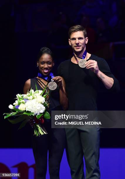 Bronze medal France's Vanessa James and Morgan Cipres pose on the podium during the medal ceremony on March 22, 2018 during the Pairs Free Skate at...