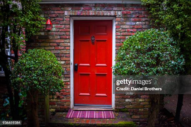 red door - brick house door stock pictures, royalty-free photos & images