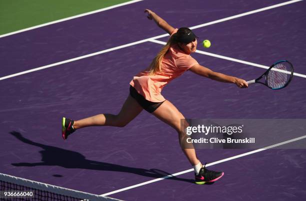 Oceane Dodin of France plays a backhand volley against Simona Halep of Romania in their second round match during the Miami Open Presented by Itau at...