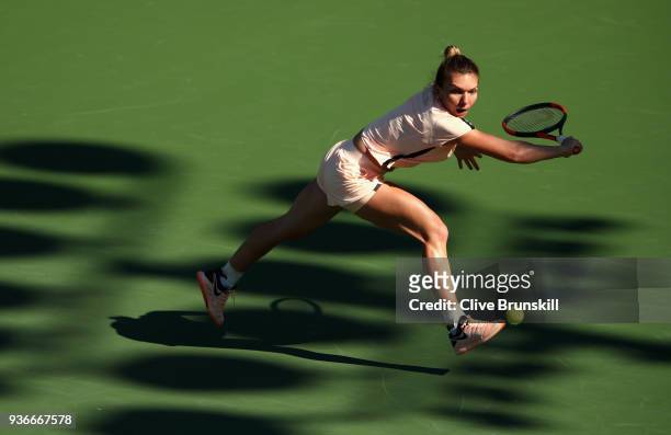 Simona Halep of Romania plays a backhand against Oceane Dodin of France in their second round match during the Miami Open Presented by Itau at...