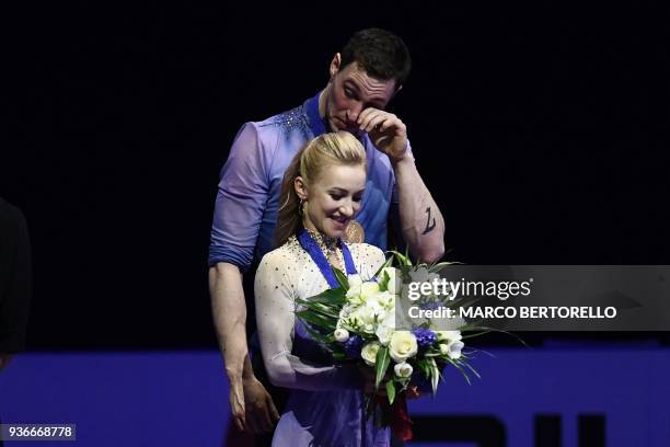 Gold medal Germany's Aljona Savchenko and Bruno Massot react on the podium during the medal ceremony on March 22, 2018 during the Pairs Free Skate at...