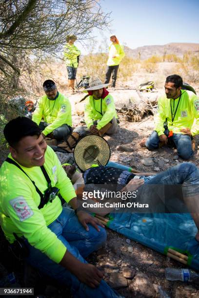 Jose Genis helps first-time volunteer Jason Bechtel after he experiences signs of heat stroke during Aguílas del Desierto search and rescue crew's...