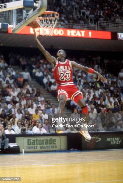 Michael Jordan of the Chicago Bulls goes in for a layup against the Miami Heat during an NBA basketball game circa 1988 at the Miami Arena in Miami,...