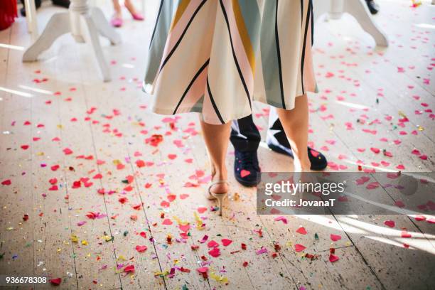 bride and groom dancing with heart confetti on floor - jovanat stock pictures, royalty-free photos & images