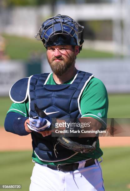 Derek Norris of the Detroit Tigers looks on while wearing a green jersey to honor St. Patricks Day during the Spring Training game against the New...