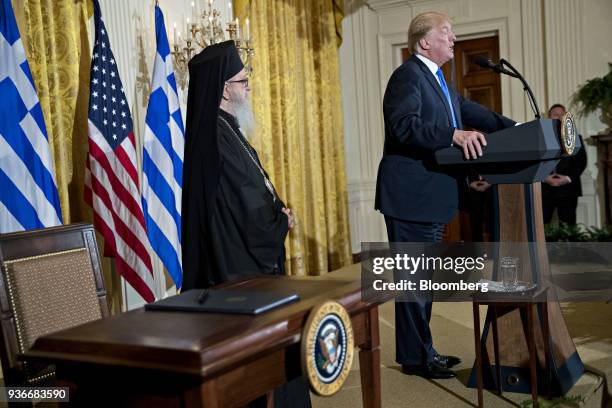 President Donald Trump speaks as Archbishop Demetrios of America, elder archbishop of the Greek Orthodox Archdiocese of America, left, listens during...