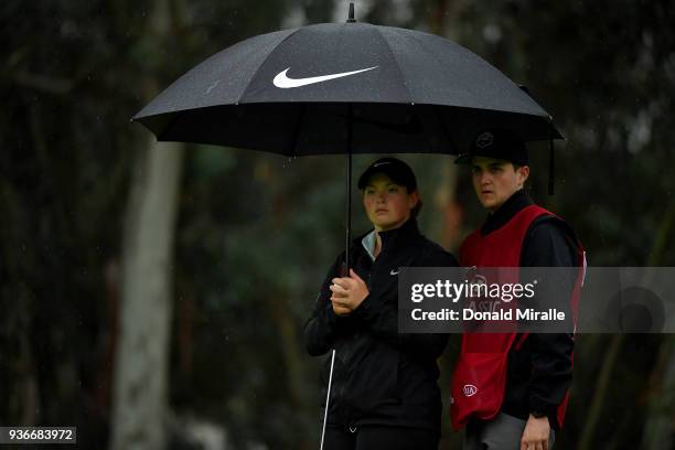 Caroline Inglis with caddy shelters under umbrella on 1st green during Round One of the LPGA KIA CLASSIC at the Park Hyatt Aviara golf course on...