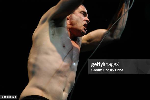Rollins Band at Nokia Theater. Henry Rollins lifts both arms over his head and regards he audience while singing in performance with Rollins Band on...