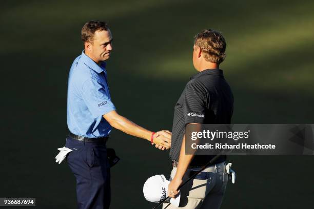 Justin Thomas of the United States shakes hands with Patton Kizzire of the United States after defeating him 3&1 on the 17th green during the second...