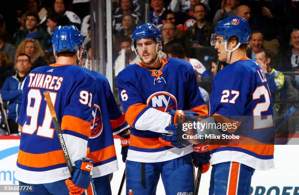 Ryan Pulock of the New York Islanders celebrates his first-period power play goal against the Tampa Bay Lightning with teammates John Tavares and...