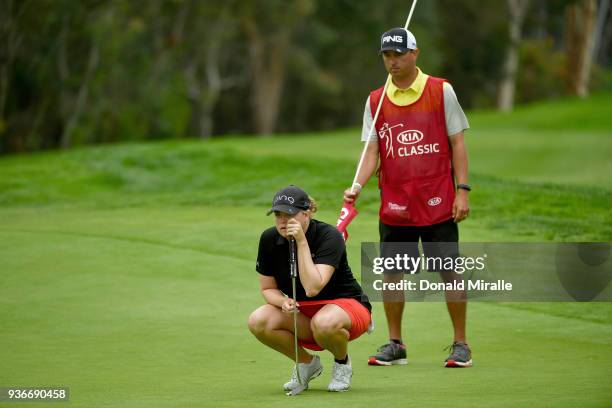 Jackie Stoelting and husband and caddie Travis Stoelting line up birdie putt on the 12th hole during Round One of the LPGA KIA CLASSIC at the Park...