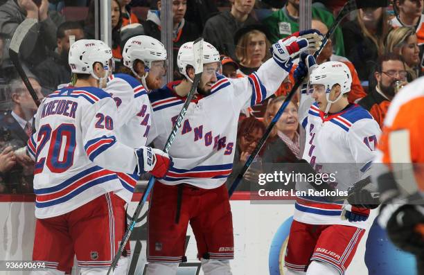 Mika Zibanejad of the New York Rangers celebrates his first period goal against the Philadelphia Flyers with teammates Chris Kreider, Marc Staal, and...
