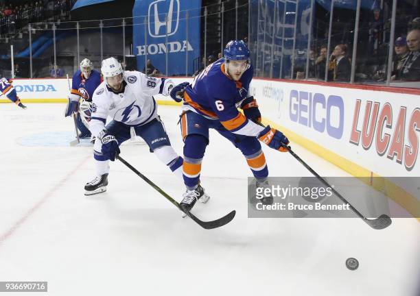 Ryan Pulock of the New York Islanders is checked by Nikita Kucherov of the Tampa Bay Lightning during the first period at the Barclays Center on...