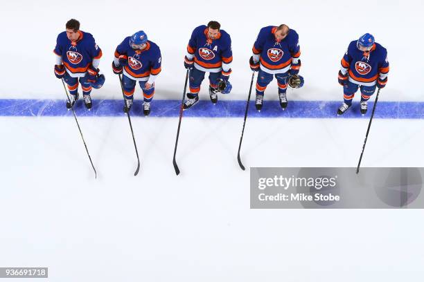 Brock Nelson, Nick Leddy, Andrew Ladd, Johnny Boychuk and Tanner Fritz of the New York Islanders line up for the national anthem prior to a game...