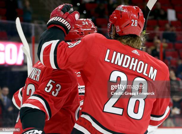 Jeff Skinner of the Carolina Hurricanes celebrates his first period goal against the Arizona Coyotes with teammates Phillip Di Giuseppe and Elias...