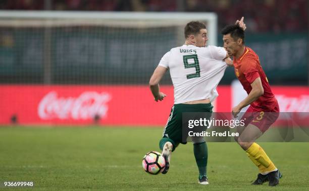 Sam Vokes of Wales and Zheng Zheng of China in action during 2018 China Cup International Football Championship between China and Wales at Guangxi...