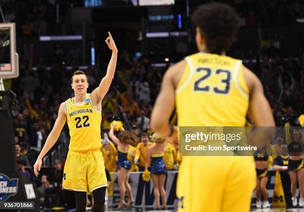 Duncan Robinson of the Michigan Wolverines celebrates after a three pointer was scored by G Ibi Watson of the Michigan Wolverines during the NCAA...