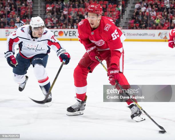 Danny DeKeyser of the Detroit Red Wings looks to shoot the puck as T.J. Oshie of the Washington Capitals reaches in front during an NHL game at...
