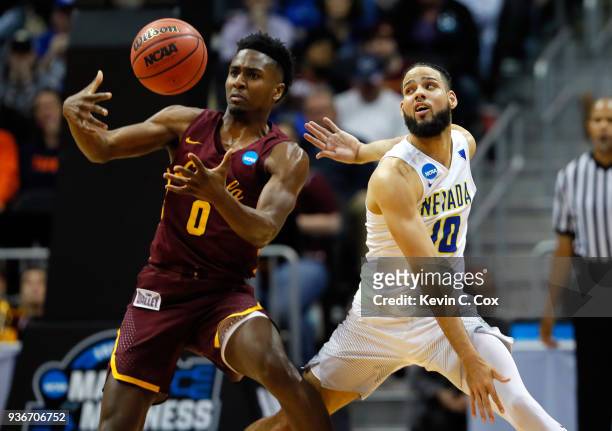 Donte Ingram of the Loyola Ramblers and Caleb Martin of the Nevada Wolf Pack compete for a loose ball in the second half during the 2018 NCAA Men's...