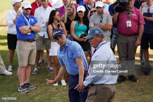 Justin Thomas of the United States speaks to rules offical Brad Fabel during the second round of the World Golf Championships-Dell Match Play at...