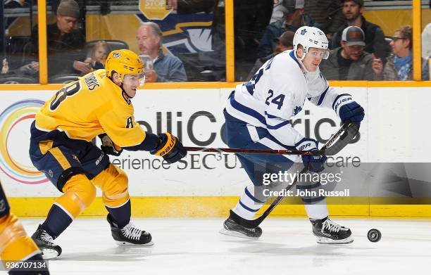 Kyle Turris of the Nashville Predators battles for the puck against Kasperi Kapanen of the Toronto Maple Leafs during an NHL game at Bridgestone...