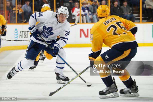 Auston Matthews of the Toronto Maple Leafs skates against Alexei Emelin of the Nashville Predators during an NHL game at Bridgestone Arena on March...