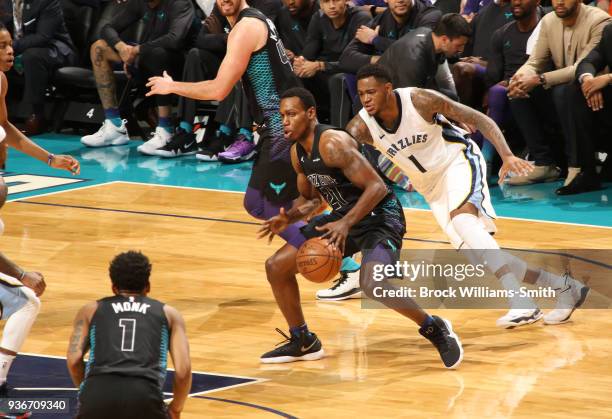 Treveon Graham of the Charlotte Hornets handles the ball against Jarell Martin of the Memphis Grizzlies on March 22, 2018 at Spectrum Center in...