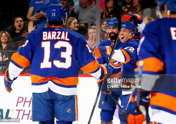 Anthony Beauvillier of the New York Islanders celebrates his second goal of the third period against the Tampa Bay Lightning with teammates Nick...