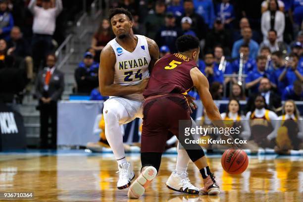 Marques Townes of the Loyola Ramblers collides with Jordan Caroline of the Nevada Wolf Pack late in the second half during the 2018 NCAA Men's...