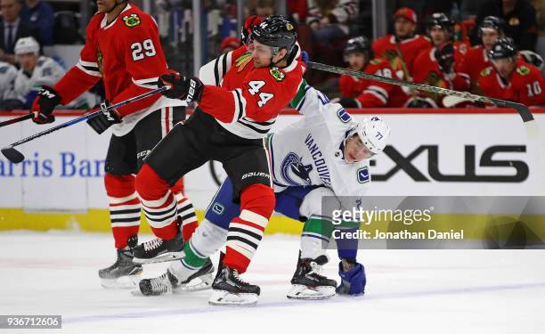 Jan Rutta of the Chicago Blackhawks collides with Nikolay Goldobin of the Vancouver Canucks at the United Center on March 22, 2018 in Chicago,...