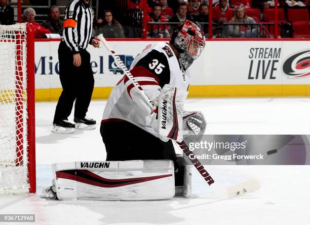 Darcy Kuemper of the Arizona Coyotes eyes a Carolina Hurricanes shot during an NHL game on March 22, 2018 at PNC Arena in Raleigh, North Carolina.