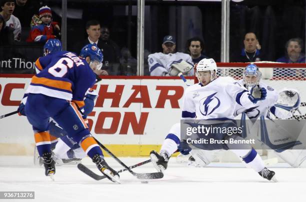 Ryan Pulock of the New York Islanders attempts to get the puck past Anthony Cirelli of the Tampa Bay Lightning during the third period at the...