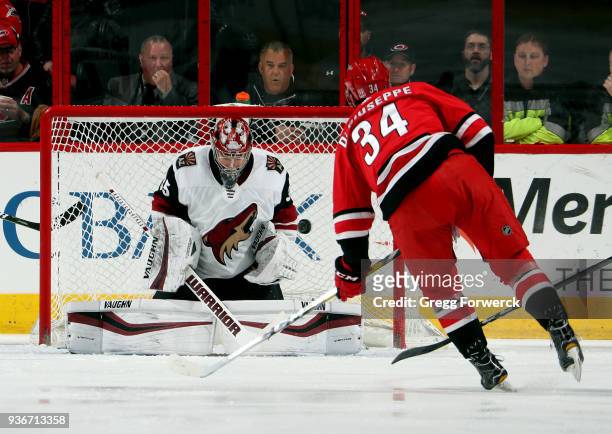 Darcy Kuemper of the Arizona Coyotes deflects a shot from Phillip Di Giuseppe of the Carolina Hurricanes during an NHL game on March 22, 2018 at PNC...