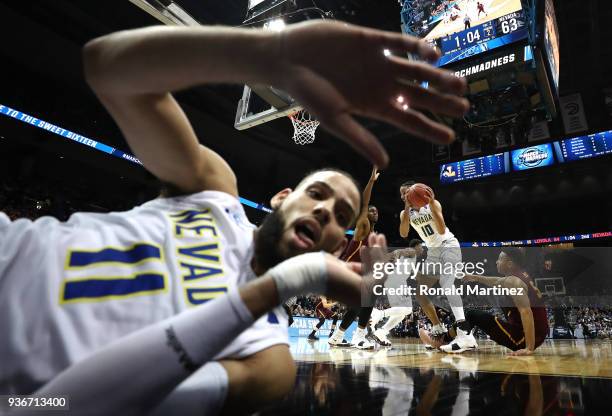 Cody Martin of the Nevada Wolf Pack falls after saving the ball with a pass to Caleb Martin in the second half against the Loyola Ramblers during the...