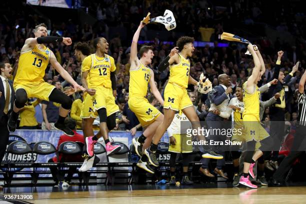 The Michigan Wolverines bench celebrates in the games final minutes against the Texas A&M Aggies in the 2018 NCAA Men's Basketball Tournament West...