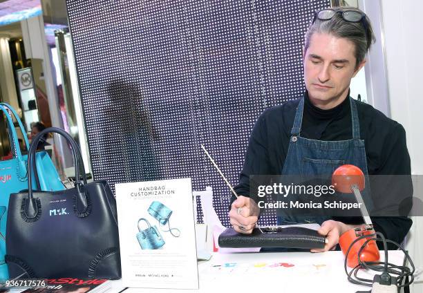 Illustrator Don Oehl personalizes handbags at the InStyle x Michael Kors Style Adventure At Macy's on March 22, 2018 in New York City.