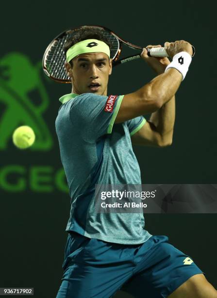 Nicolas Kicker of Argentina plays a shot against Frances Tiafoe during Day 4 of the Miami Open at the Crandon Park Tennis Center on March 22, 2018 in...