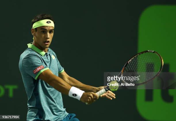 Nicolas Kicker of Argentina plays a shot against Frances Tiafoe during Day 4 of the Miami Open at the Crandon Park Tennis Center on March 22, 2018 in...