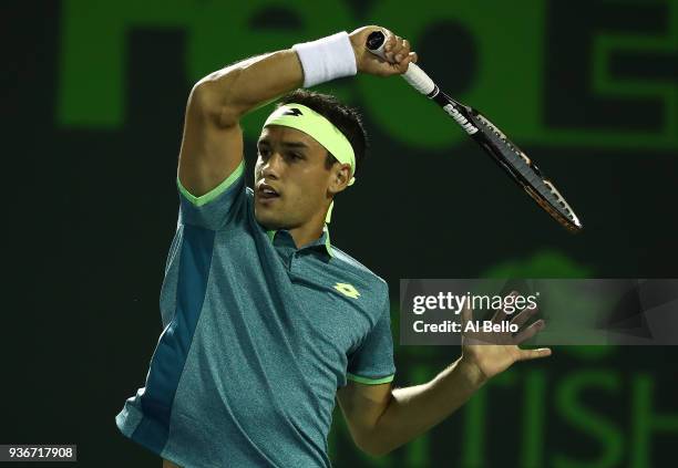 Nicolas Kicker of Argentina plays a shot against Frances Tiafoe during Day 4 of the Miami Open at the Crandon Park Tennis Center on March 22, 2018 in...