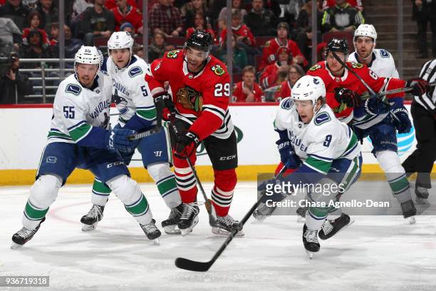 Andreas Martinsen of the Chicago Blackhawks watches for the puck against Alex Biega and Brendan Leipsic of the Vancouver Canucks in the second period...