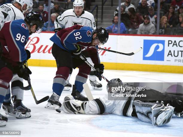 Los Angeles Kings goaltender Jonathan Quick scrambles onto ice for the puck as Colorado Avalanche left wing Gabriel Landeskog and right wing Mikko...