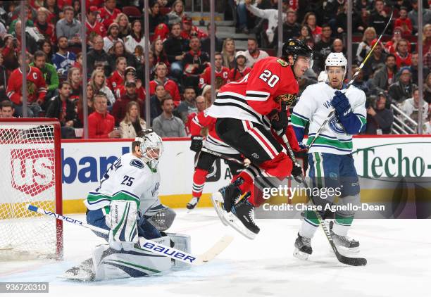 Brandon Saad of the Chicago Blackhawks jumps in front of goalie Jacob Markstrom of the Vancouver Canucks in the second period at the United Center on...