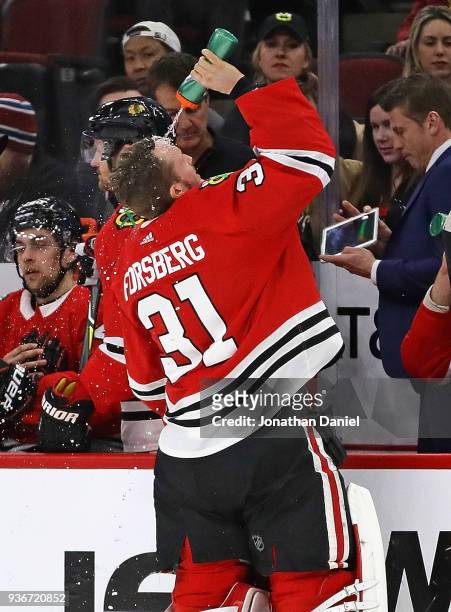 Anton Forsberg of the Chicago Blackhawks sprays water on himself before entering the game in the second period replacing starting goalie J-F Berube...